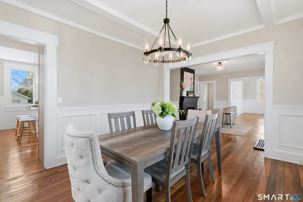 a view of a dining room with furniture wooden floor and chandelier