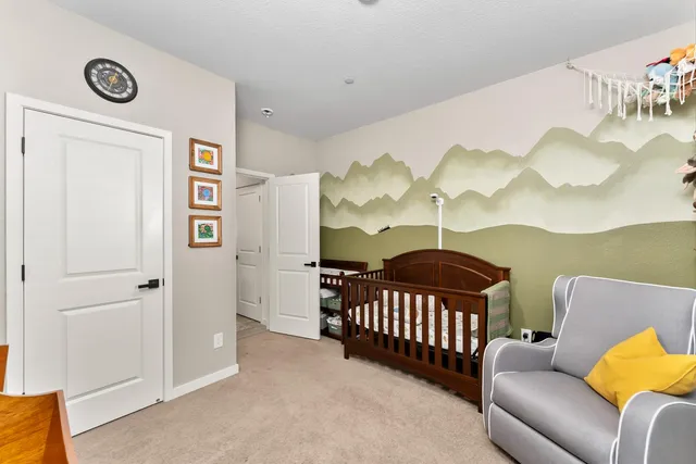 a living room with furniture a flat screen tv and a wall painting