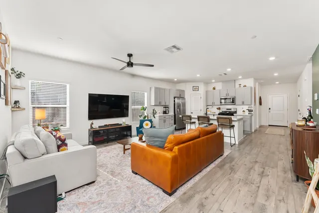 a bedroom with a bed next to a window and a flat screen tv