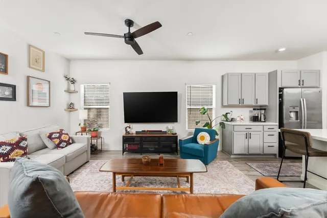 a bedroom with a bed and a dresser with rug