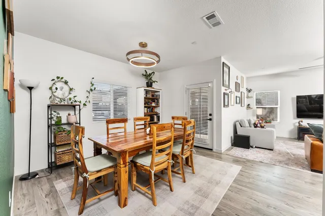 a view of a patio with a table and chairs and potted plants