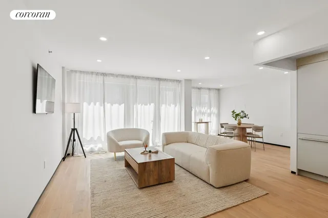 a living room with furniture and large window