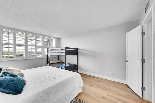 a bedroom with a bed and a large window