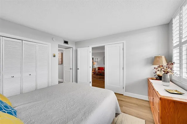 a bedroom with a bed and a view of kitchen
