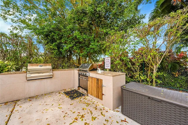 a view of a street with couches and a barbeque