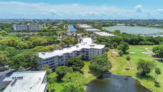 an aerial view of a house with a yard and lake view