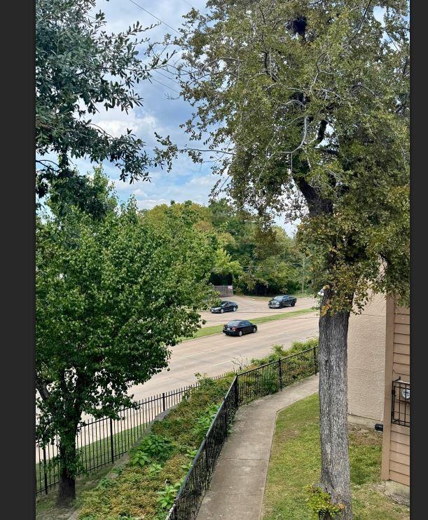 8110 Skillman Street, Unit 2057 Dallas, TX 75231 - Photo 14 of 16 a view of a yard with plants and a large tree