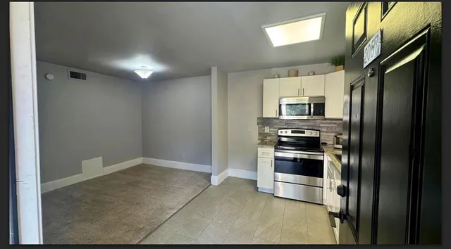 a kitchen with stainless steel appliances a refrigerator and a stove top oven