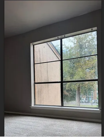a view of a large window with a small yard