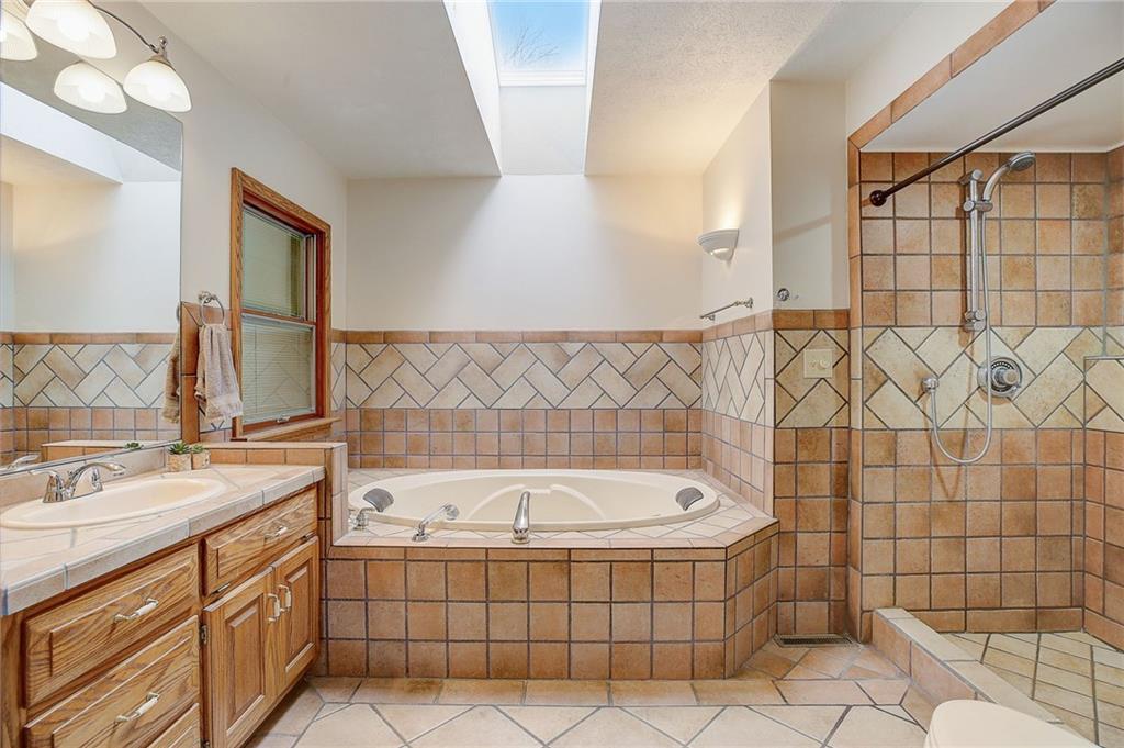 1199 Lower Mateer Road Vandergrift, PA 15690 - Photo 25 of 45 a bathroom with a tub a sink and a shower