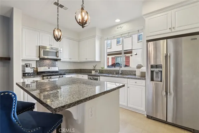 a kitchen with a counter space cabinets and stainless steel appliances