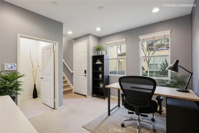 a bedroom with a bed and a lamp on dresser