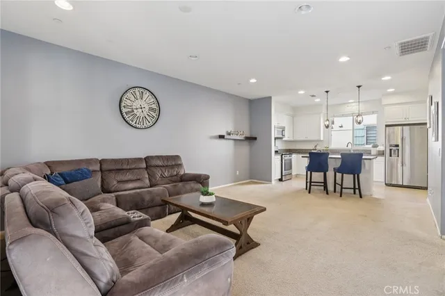 a living room with furniture and kitchen view