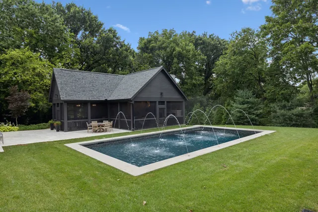 a view of a house with swimming pool and sitting area