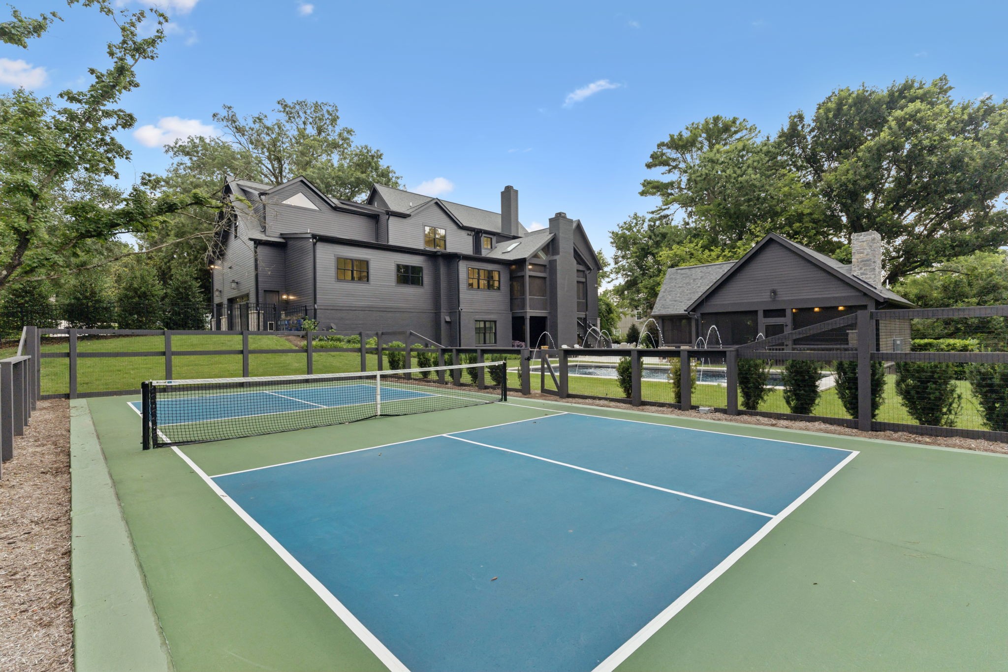 910 Robertson Academy Road Nashville, TN 37220 - Photo 51 of 57 a view of a tennis ground with large trees
