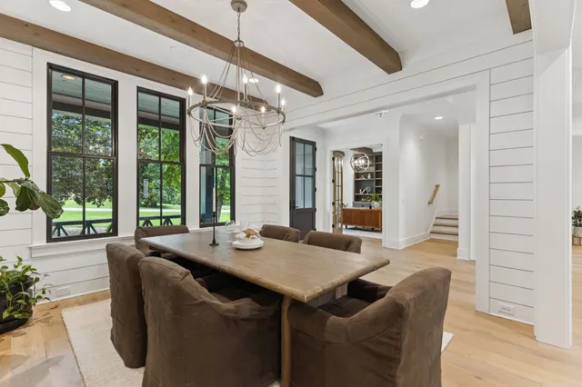 a view of a dining room with furniture wooden floor and chandelier