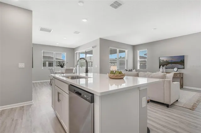 a kitchen with counter top space sink and center island