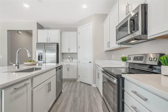 a kitchen with a sink stove and cabinets