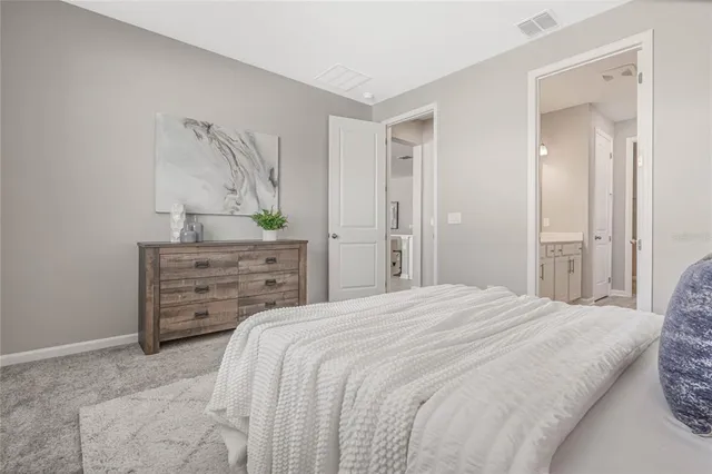 a bedroom with a bed and a dresser