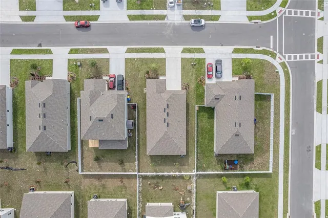 an aerial view of residential houses with outdoor space