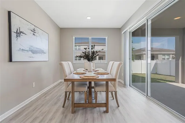 a view of a dining room with furniture window and wooden floor