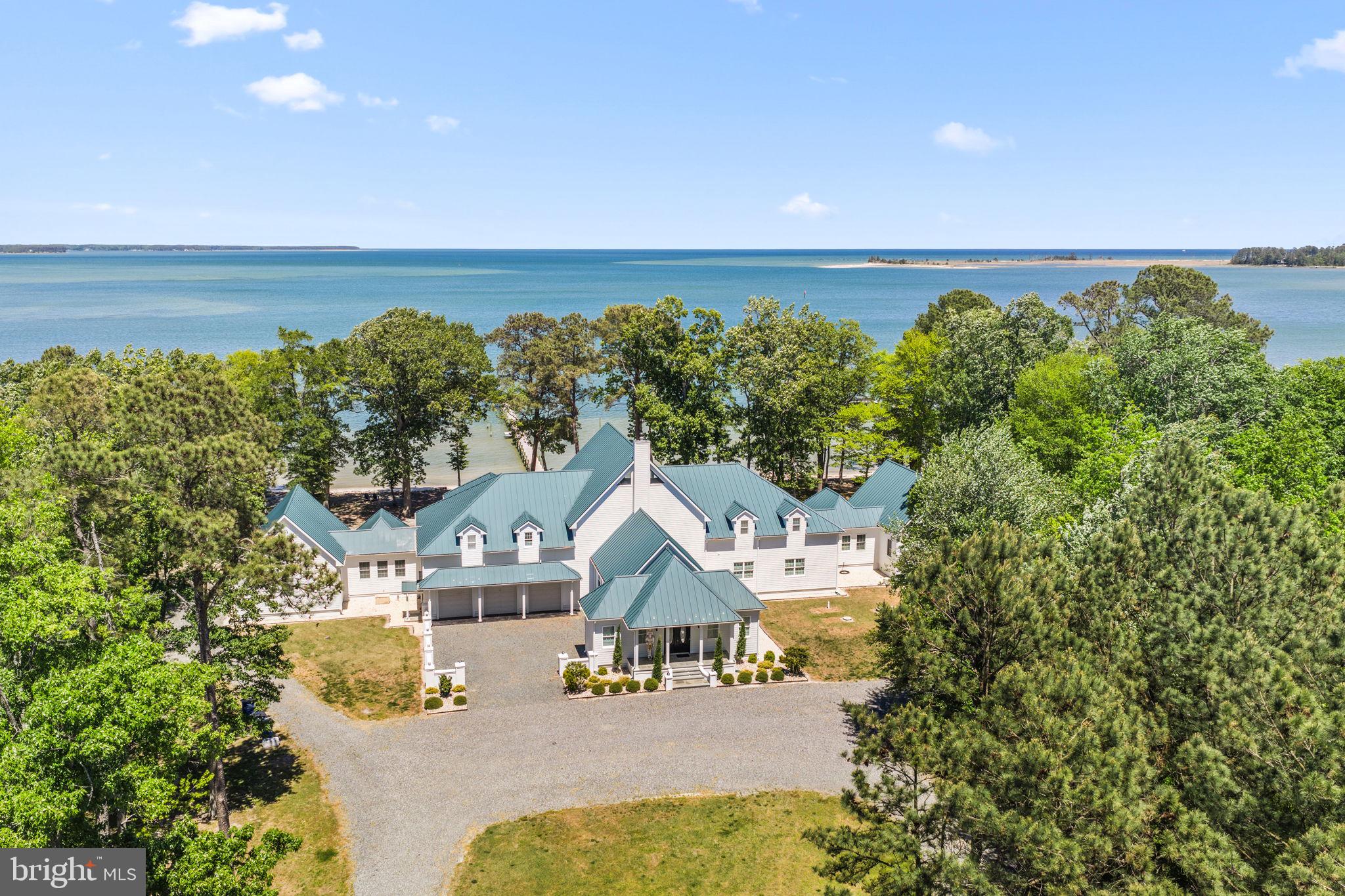an aerial view of a house with swimming pool and garden