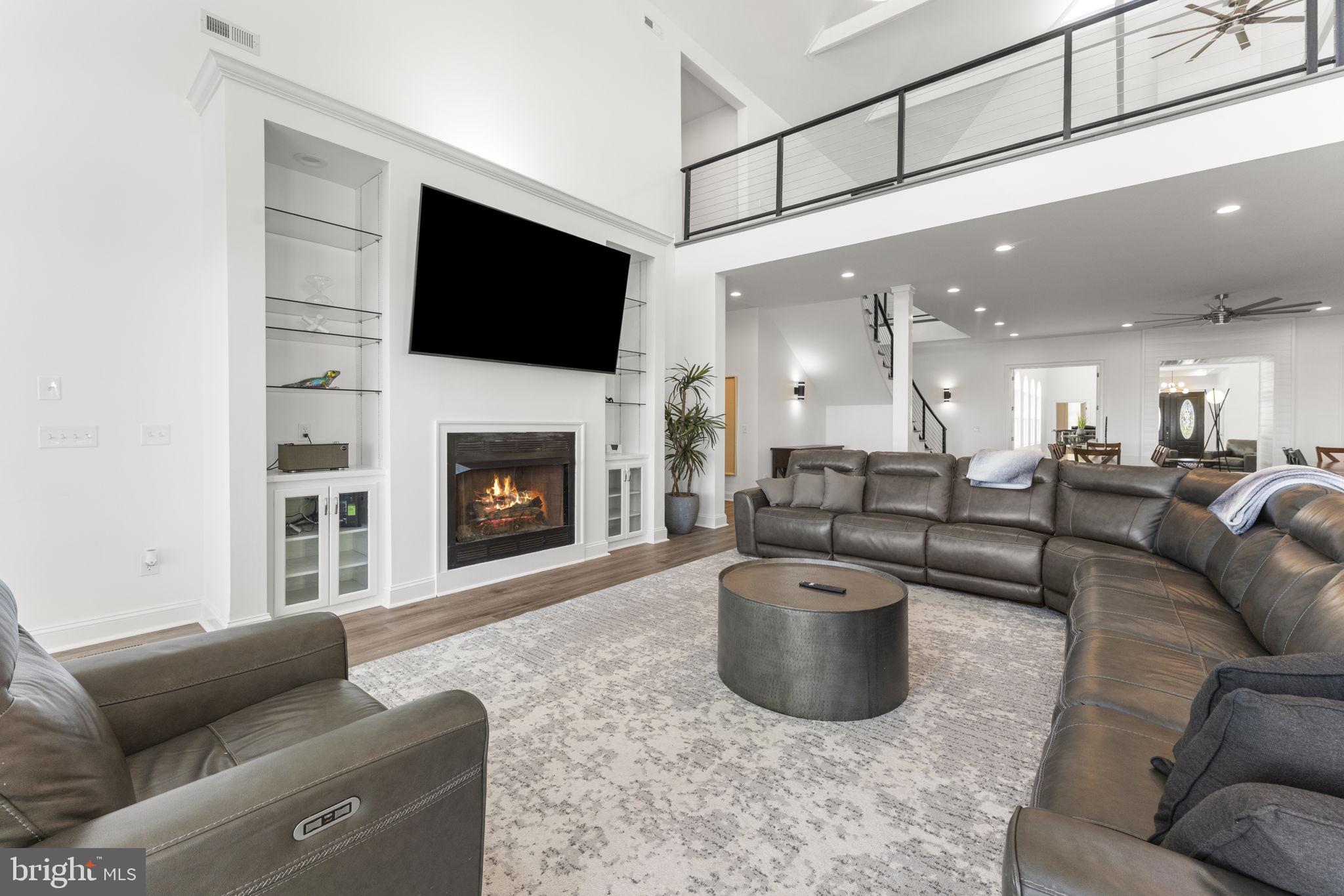 3315 Windmill Point Road White Stone, VA 22578 - Photo 13 of 45 a living room with furniture a flat screen tv and a fireplace