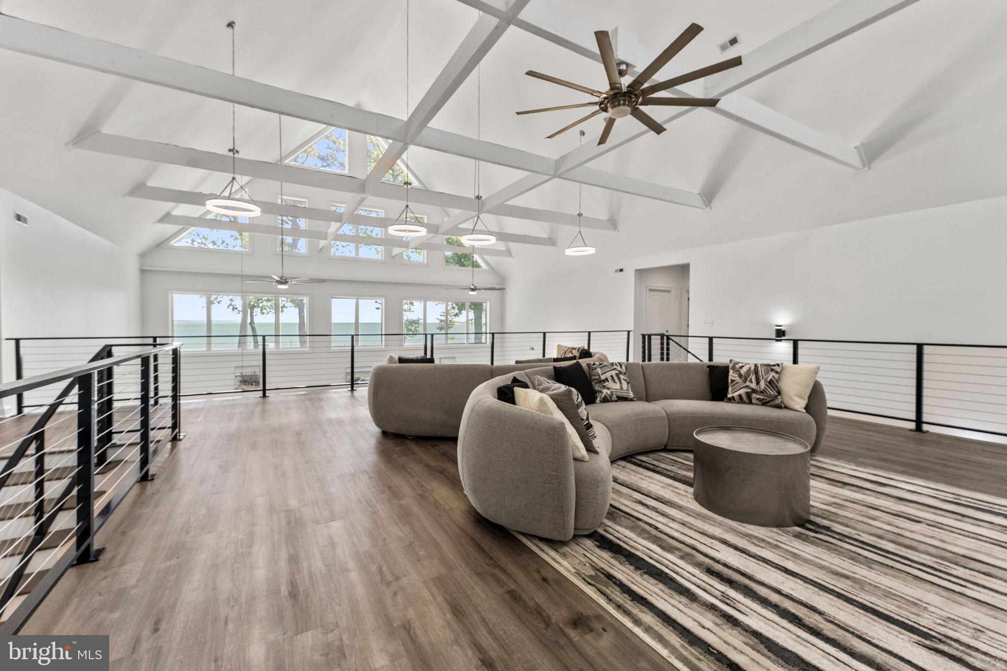 3315 Windmill Point Road White Stone, VA 22578 - Photo 20 of 45 a living room with furniture a ceiling fan and a rug