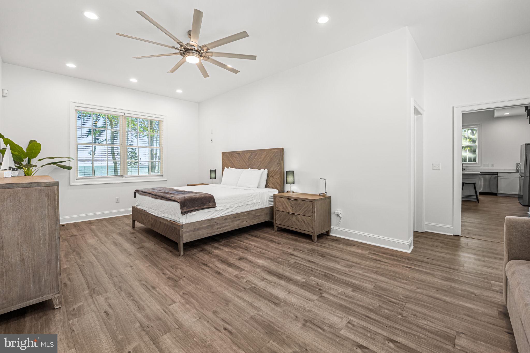 3315 Windmill Point Road White Stone, VA 22578 - Photo 26 of 45 a spacious bedroom with a bed and a couch