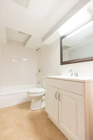 a bathroom with a sink a toilet and mirror