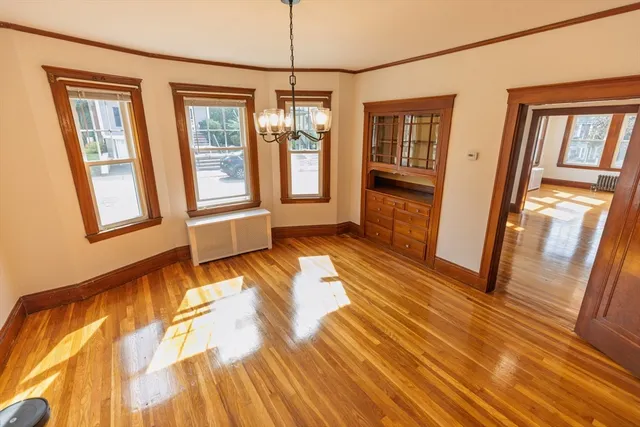 a view of an entryway with wooden floor and door