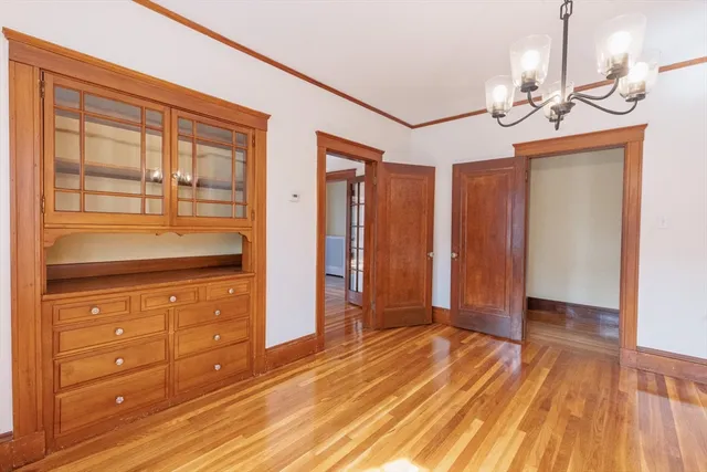 a view of a livingroom with wooden floor and cabinet