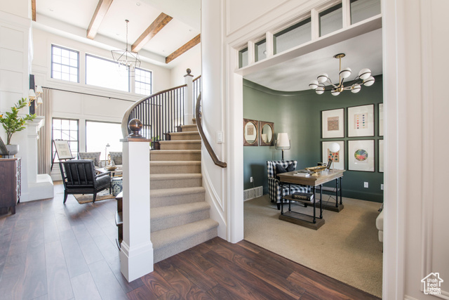 1547 North 1350 E Street, Unit 2 Mapleton, UT 84664 - Photo 12 of 18 Staircase featuring a chandelier, wood finished floors, a towering ceiling, and beam ceiling