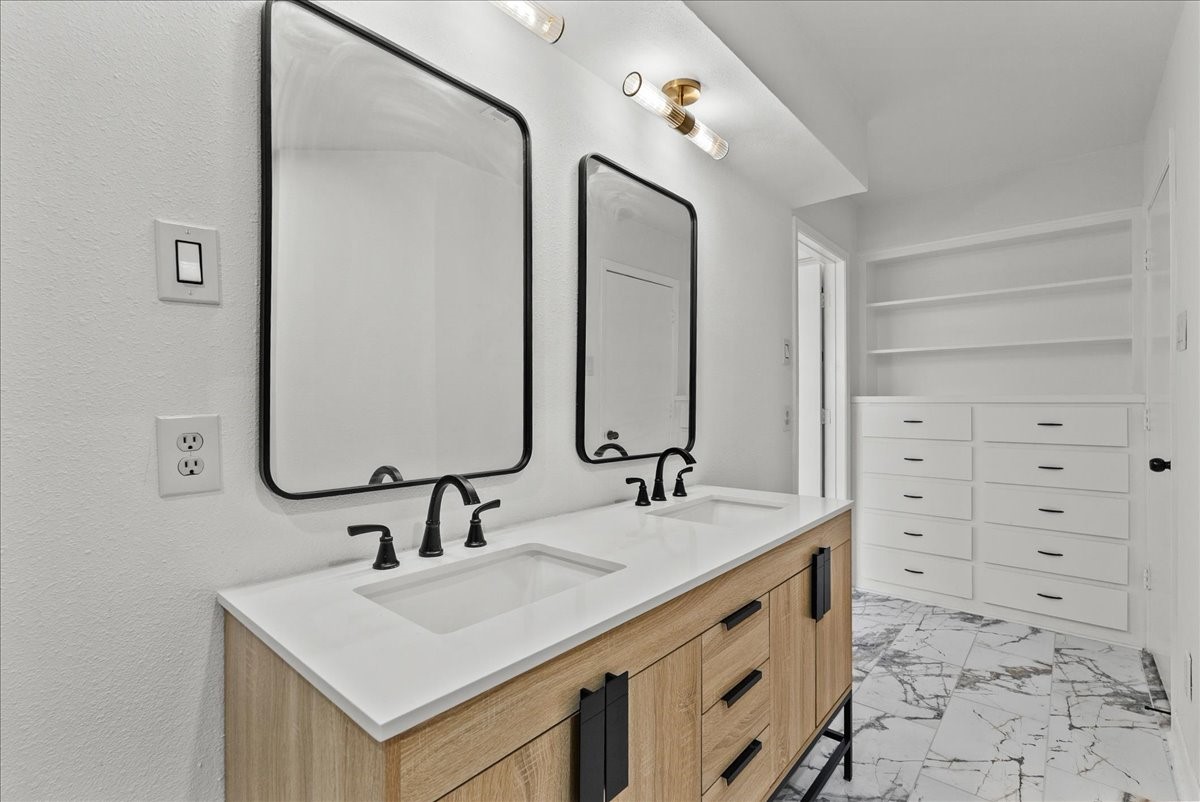 5762 Birdwood Road Houston, TX 77096 - Photo 28 of 50 HIGH END LIGHTING & CABINETRY MAKE MORNING ROUTINES A SPA-LIKE EXPERIENCE. NOTICE THE NUMEROUS DRAWERS FOR EXTRA STORAGE.