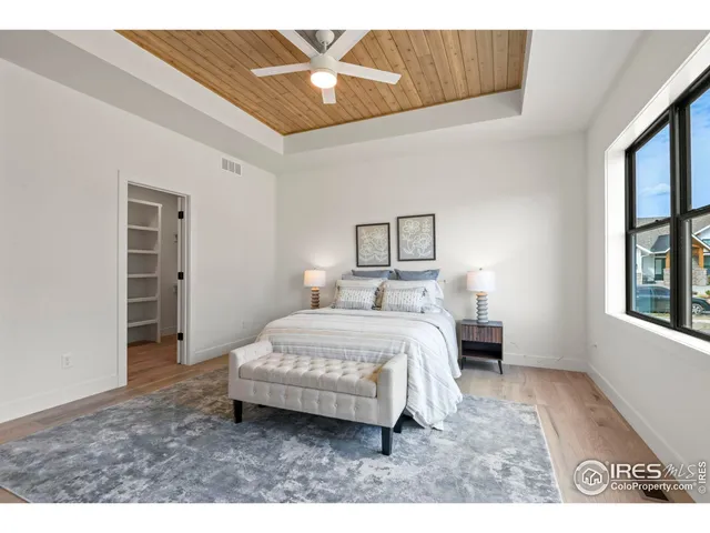 a bedroom with a large bed and a chandelier