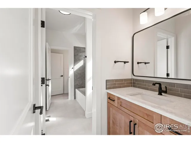 a bathroom with a tub shower and sink