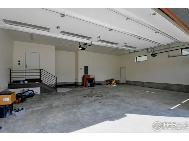 a view of a terrace with lawn chairs and a floor to ceiling window