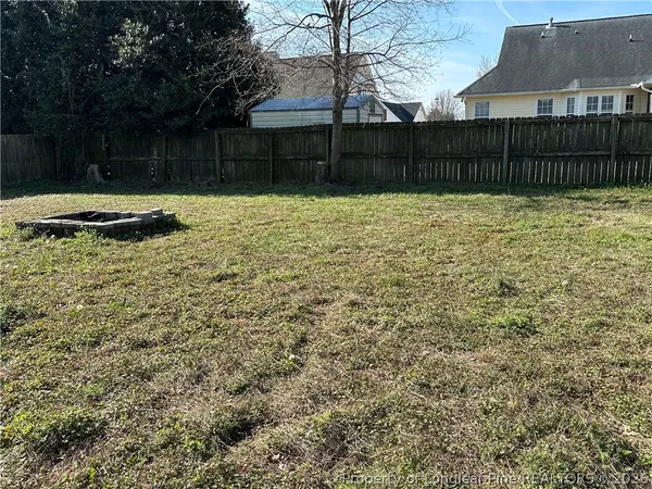 a backyard of a house with large trees