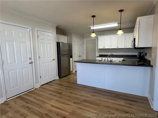 a kitchen with a sink stove and cabinets
