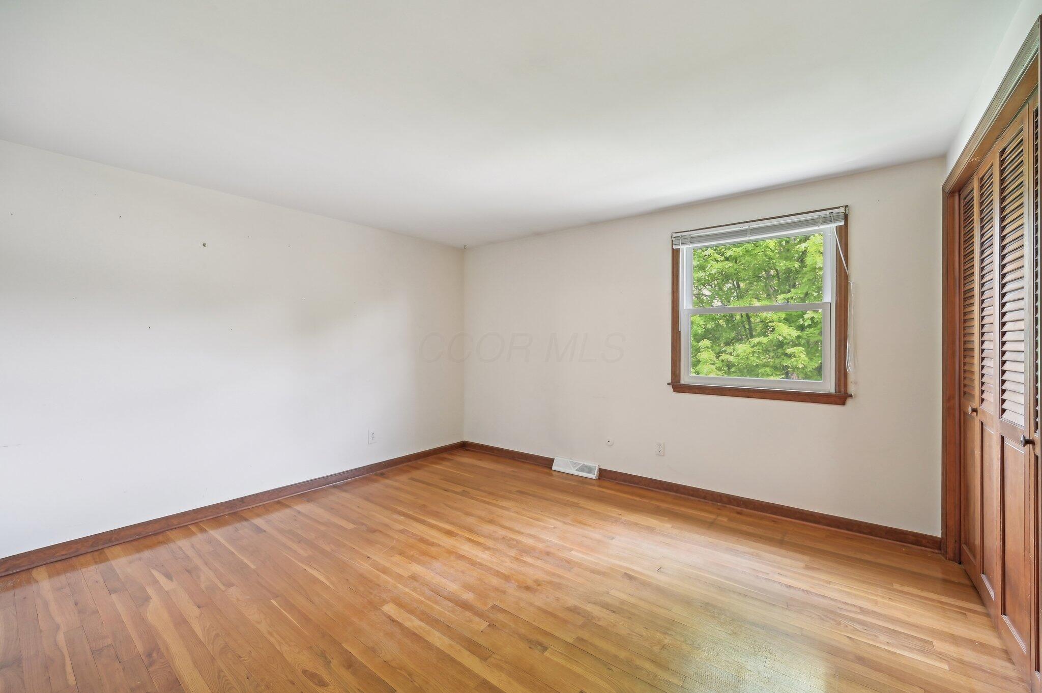 5917 Rocky Rill Road Columbus, OH 43235 - Photo 29 of 47 Secondary bedroom with hardwood flooring, large window for natural light, and neutral wall color.