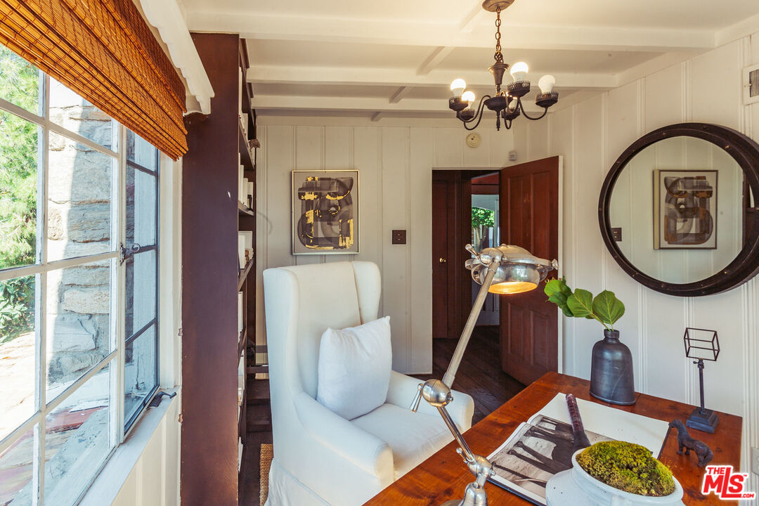 2780 Outpost Drive Los Angeles, CA 90068 - Photo 11 of 20 a living room with furniture a chandelier and a large mirror next to a window