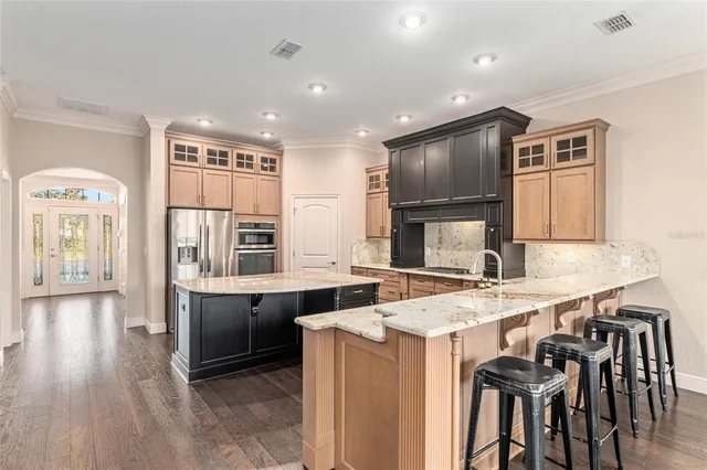 a kitchen with granite countertop a stove and a wooden floors
