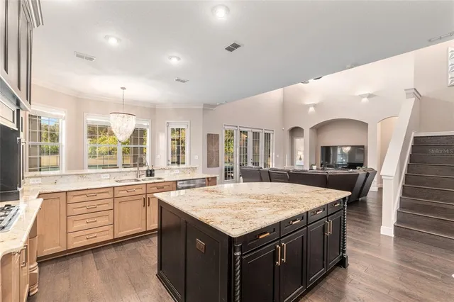 a spacious bedroom with a bed and wooden floor