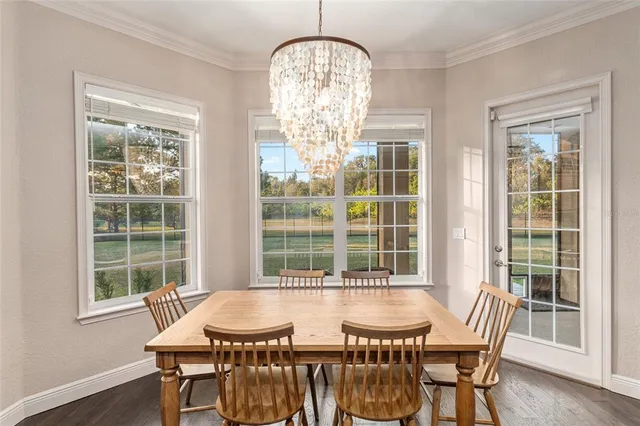 a spacious bedroom with a bed and a chandelier