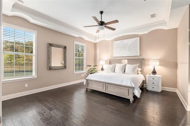 a bathroom with a granite countertop toilet sink and mirror
