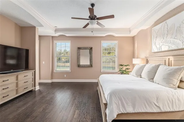 a view of a hallway with wooden floor and a bathroom