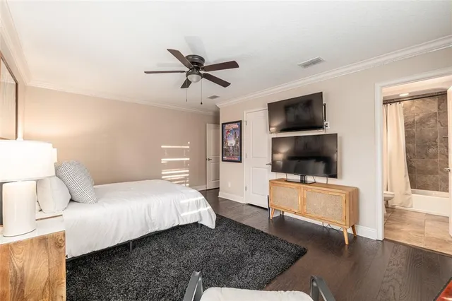 an aerial view of residential houses with outdoor space and trees