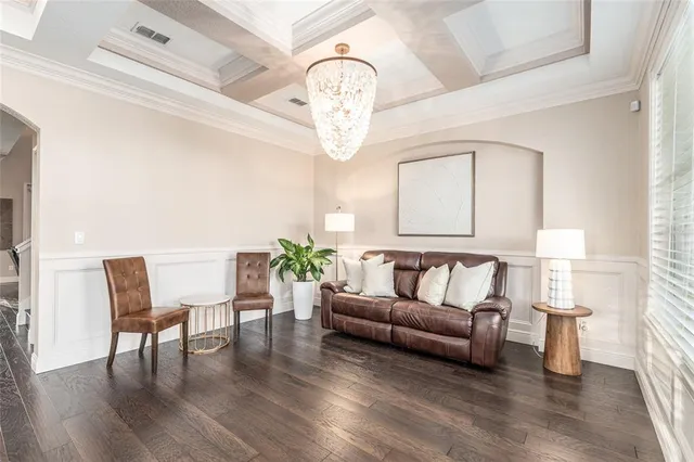 a dining room with furniture potted plants and wooden floor