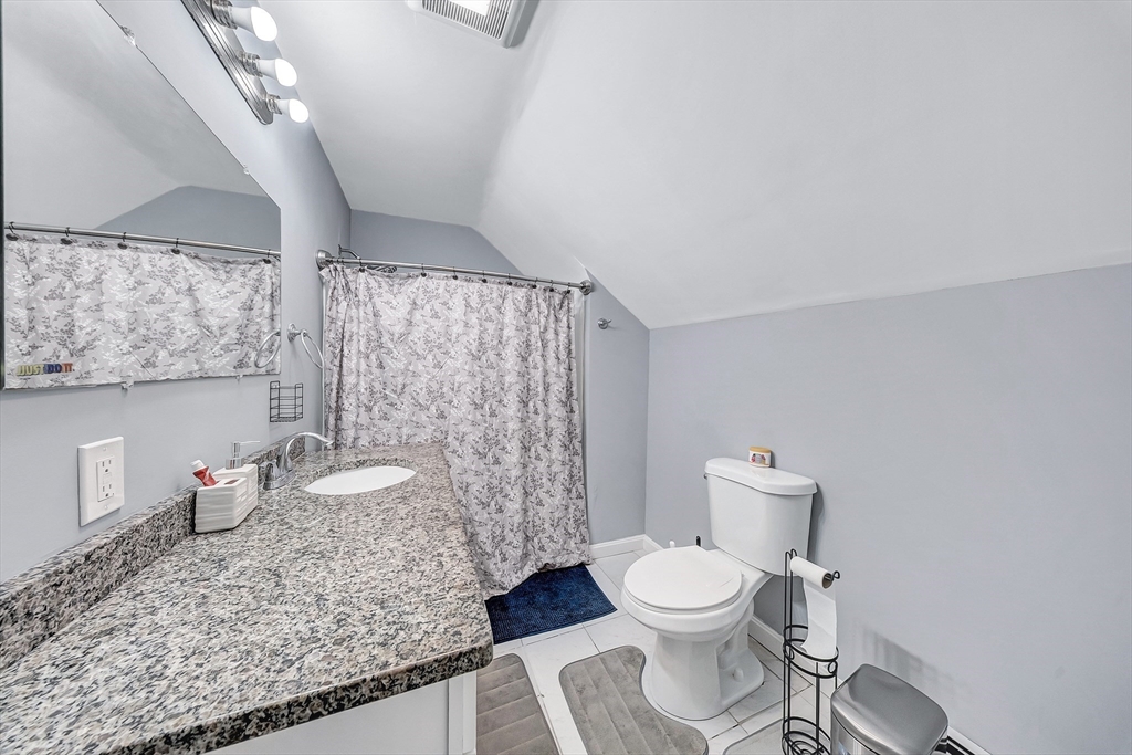 30 Fuller Street Seekonk, MA 02771 - Photo 20 of 42 a white toilet sitting next to a shower curtain
