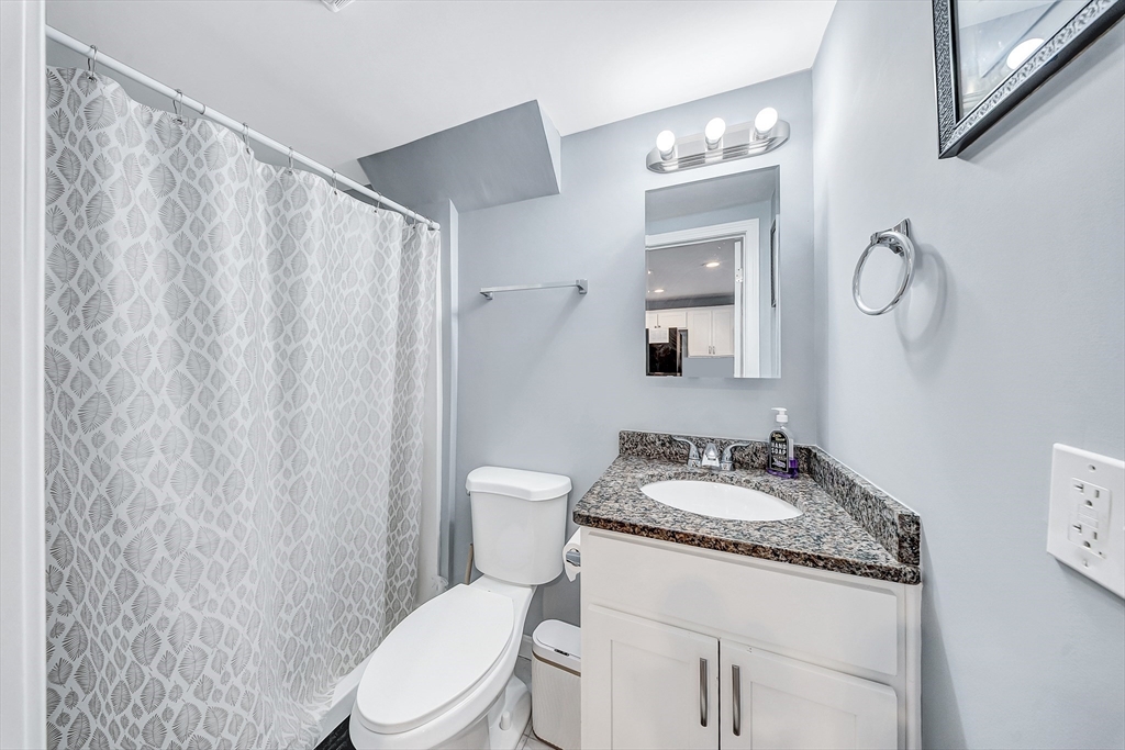 30 Fuller Street Seekonk, MA 02771 - Photo 23 of 42 a white toilet sitting next to a bathroom sink vanity and granite